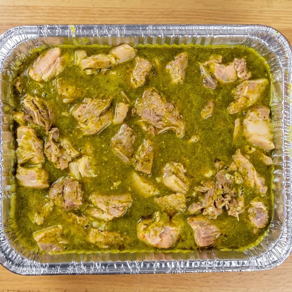 Taquerias Atotonilco's pork in green salsa, served in a large aluminum catering pan.